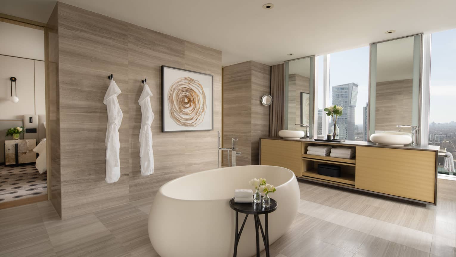 Royal Suite bathroom with standalone tub in the middle of the room, double vanity and windows, at Four Seasons Hotel Toronto