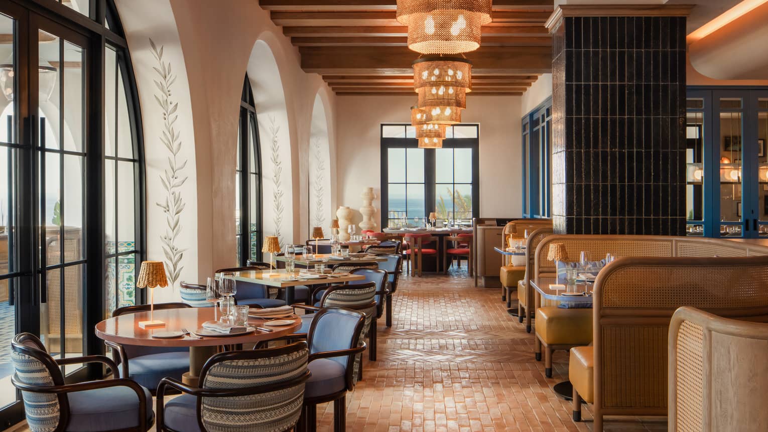 Indoor restaurant, warm tile floors, a row of rattan hanging lights, leather boots and four-chair tables ? Palmerio at Four Seasons Resort and Residences Cabo San Lucas
