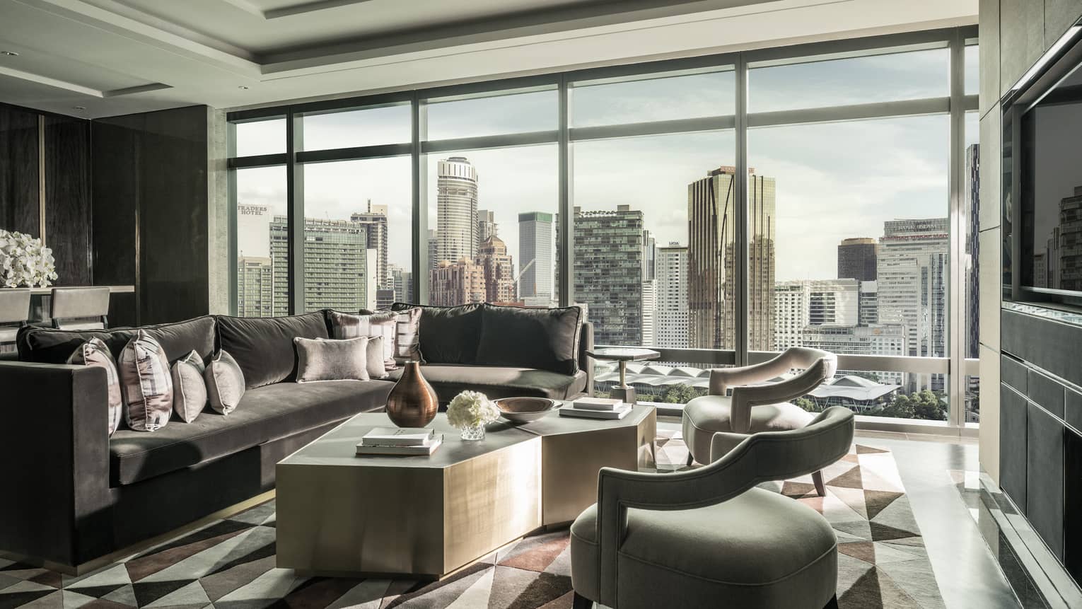 Sunny Presidential Suite seating area by floor-to-ceiling windows