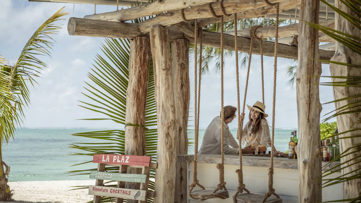 Couple relaxes outdoors at La Plaz Beach Bar