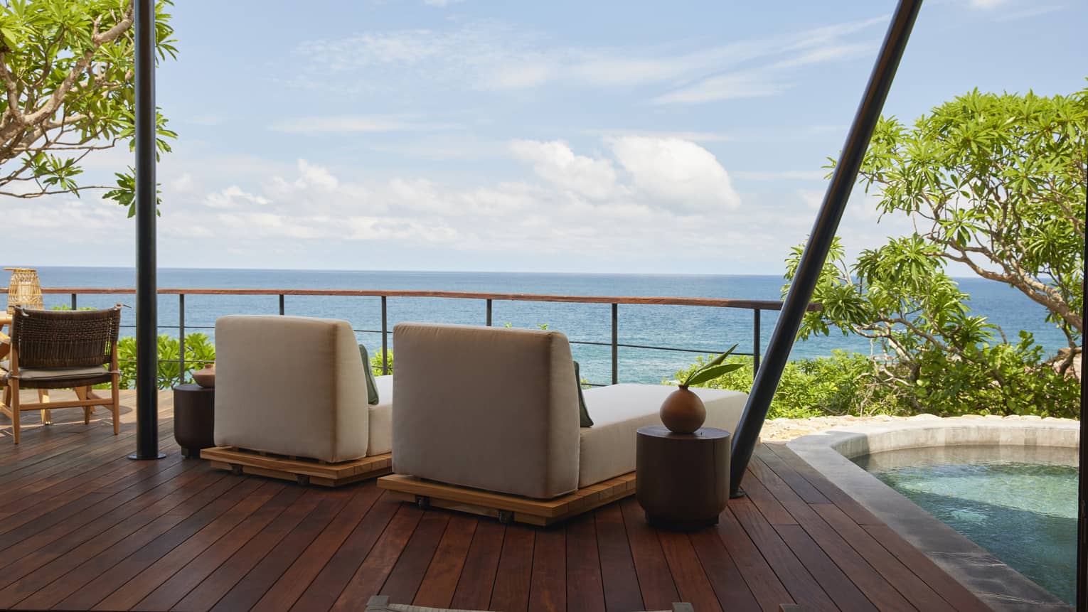 Shaded deck of luxury tent overlooking the ocean, with private plunge pool and two lounge chairs