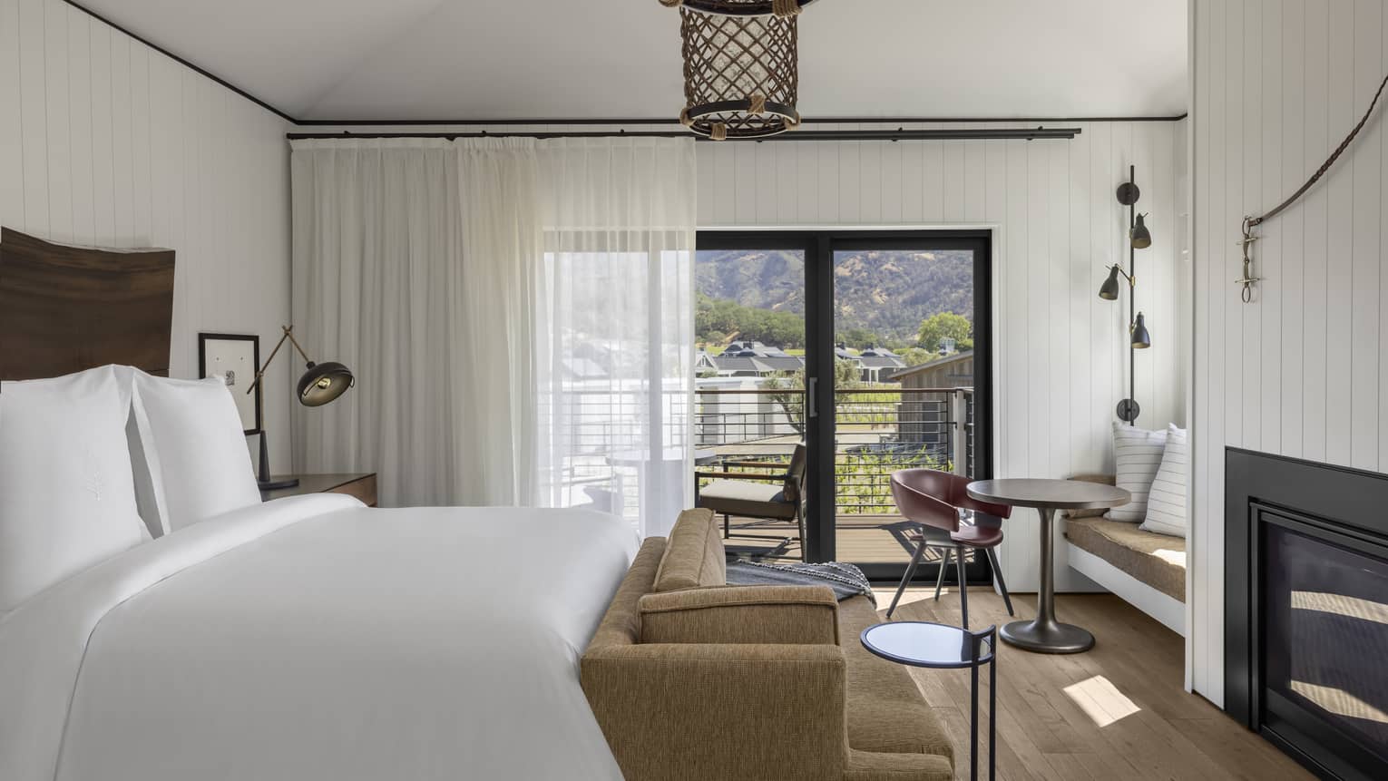 Bedroom with fireplace, walk-out balcony, hanging whicker chandelier