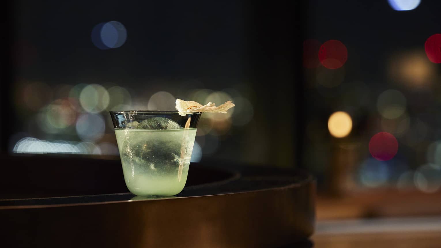 Green cocktail with milk foam cracker