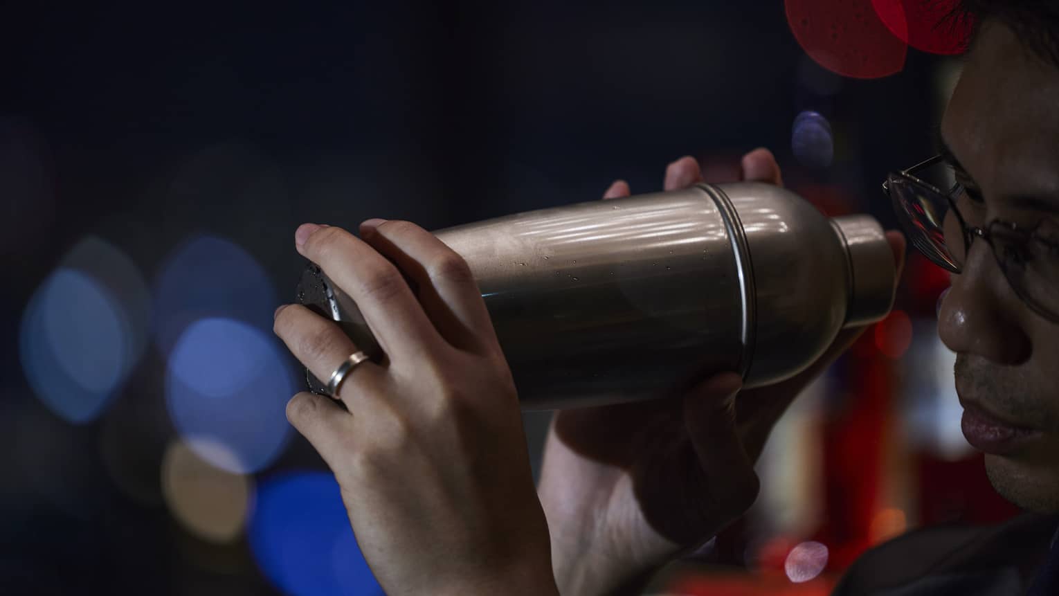 Bartender holds a cocktail shaker