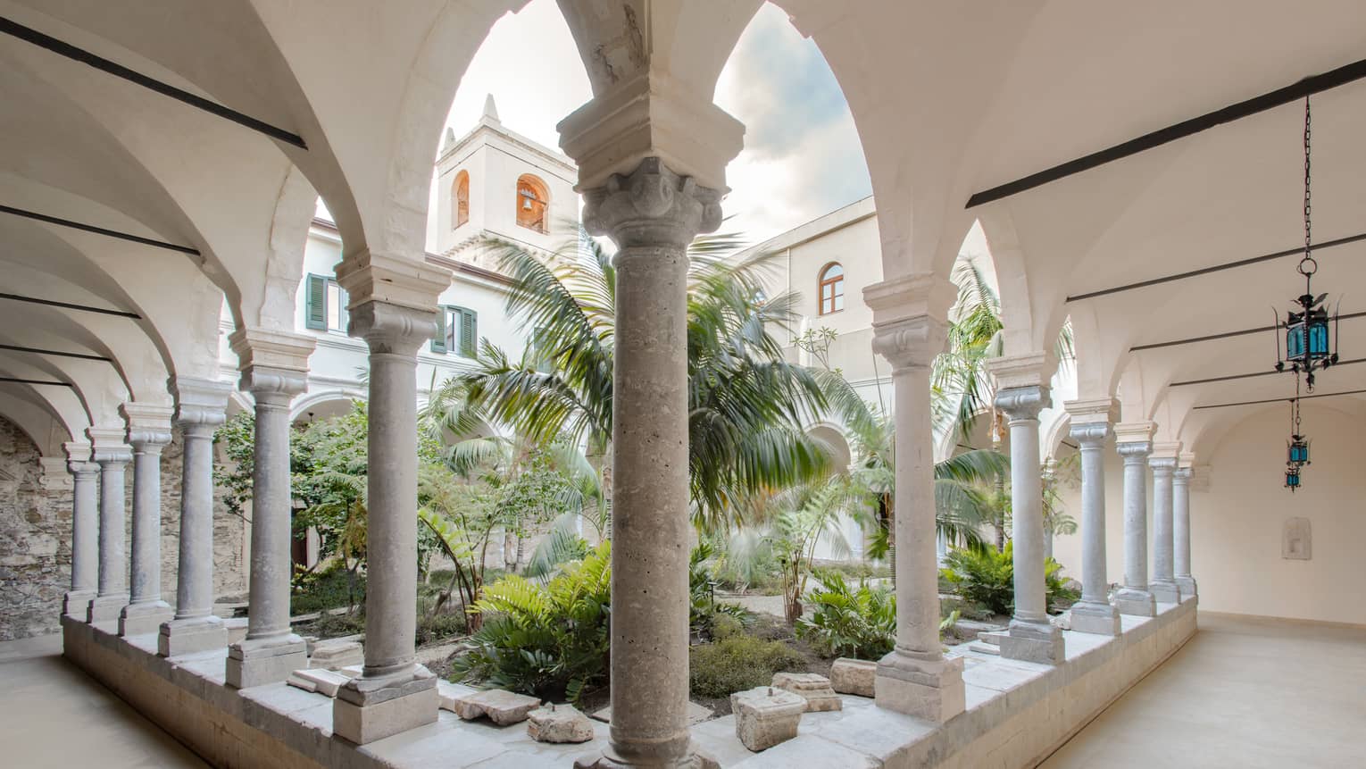 Outdoor cloister courtyard, palm trees in the middle