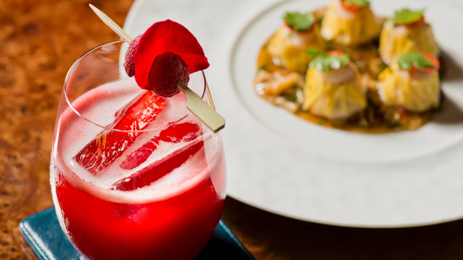 Crackling Rose non-alcoholic red cocktail with fresh berry garnish on toothpick