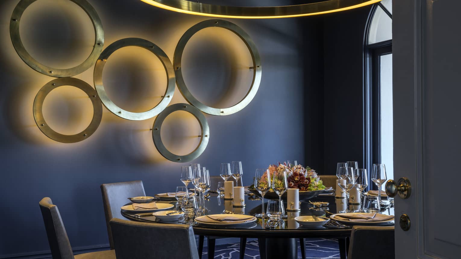 Blue room private dining table below wall with modern gold rings