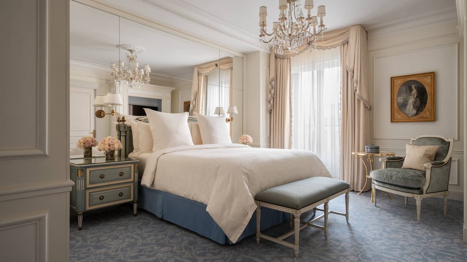 Deluxe Suite bed, elegant furniture under small chandelier