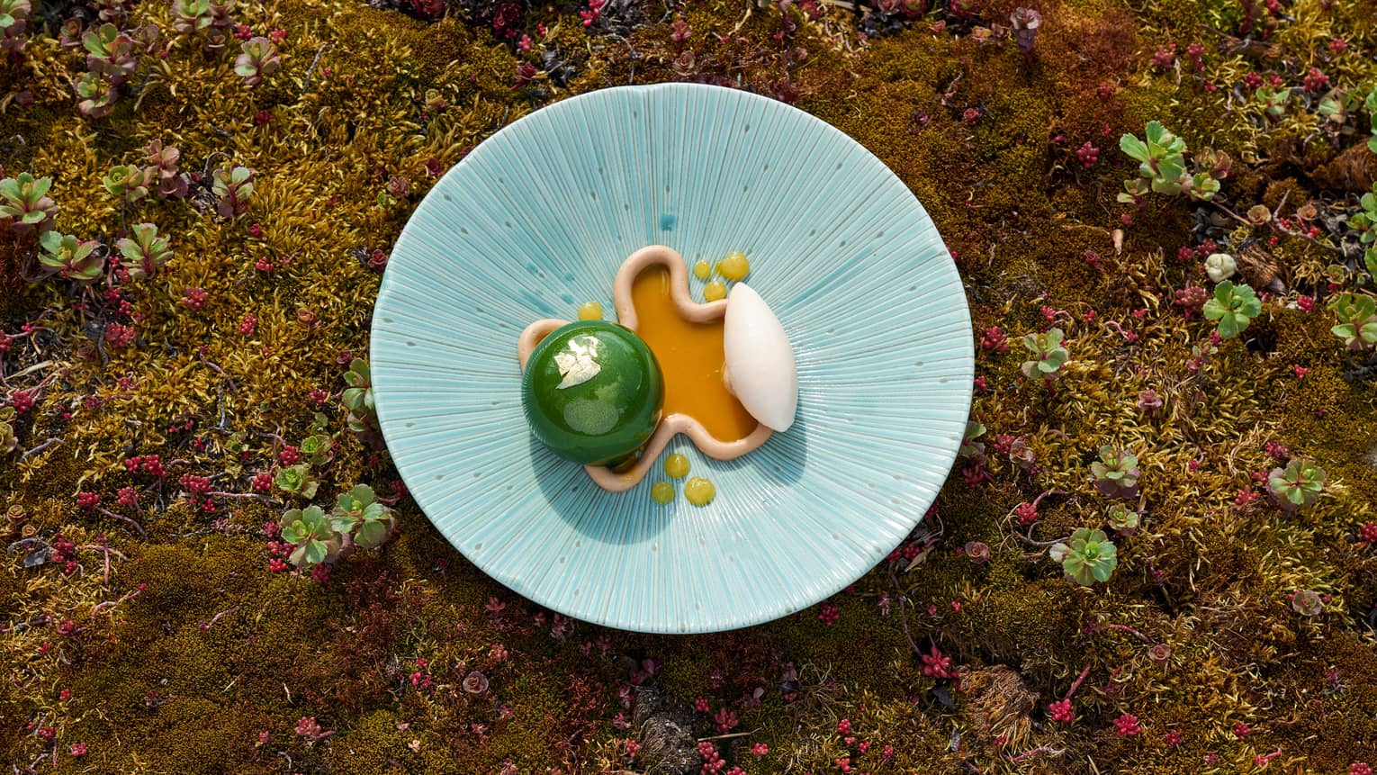Matcha Mousse sphere beside Mango Sauce trimmed with white sorbet