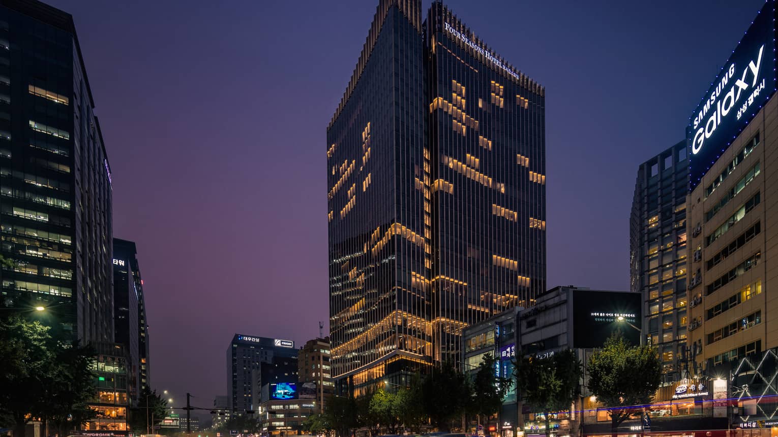 Four Seasons Hotel Seoul glass high rise building exterior with lights at night