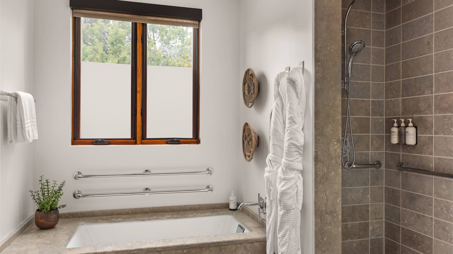 Bathroom with sunken tab, grab bars, window and accessible shower at Four Seasons Resort Santa Fe
