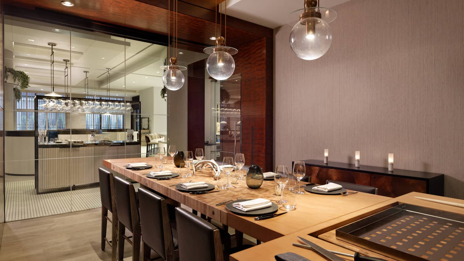 A large dining table with a carving station next to a clean open kitchen.