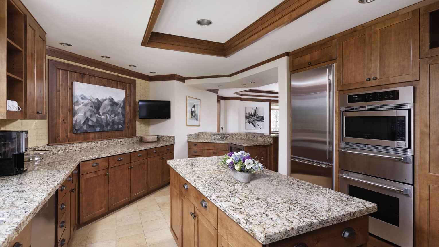 Kitchen with granite countertops and wooden cabinetry and island