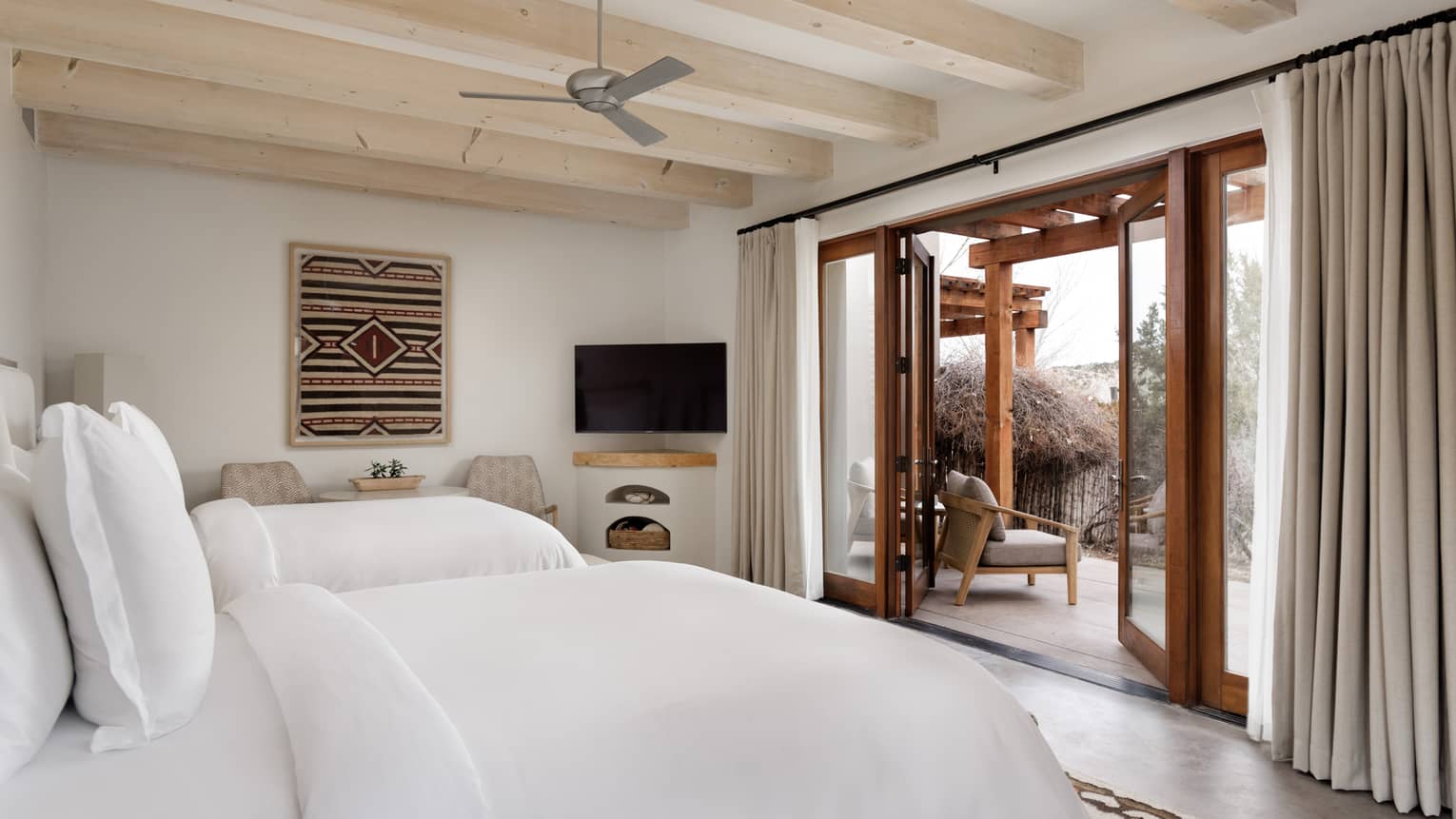 Guest room with two queen beds and walk-out terrace at Four Seasons Resort Santa Fe