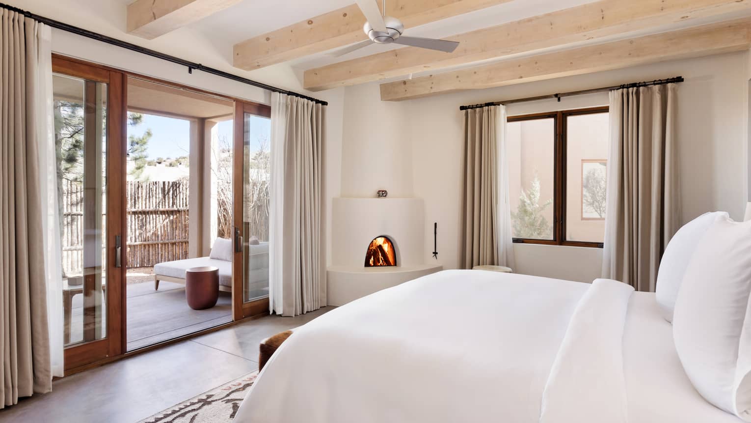 King-bedded hotel room with patio at Four Seasons Resort Santa Fe