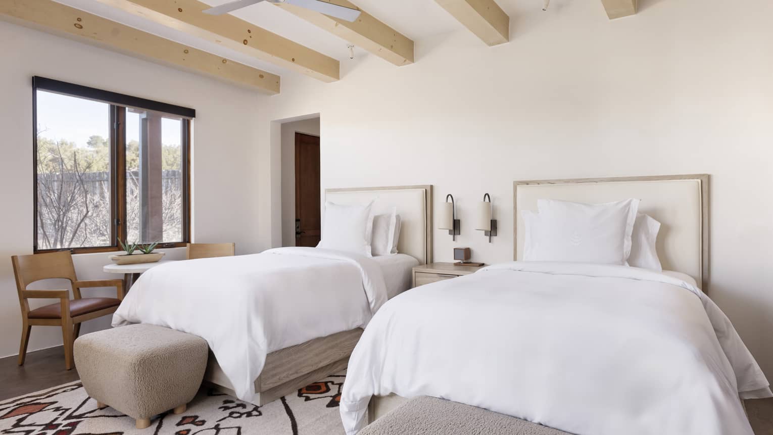 Guest room with two double beds and windowside table and chairs at Four Seasons Resort Santa Fe