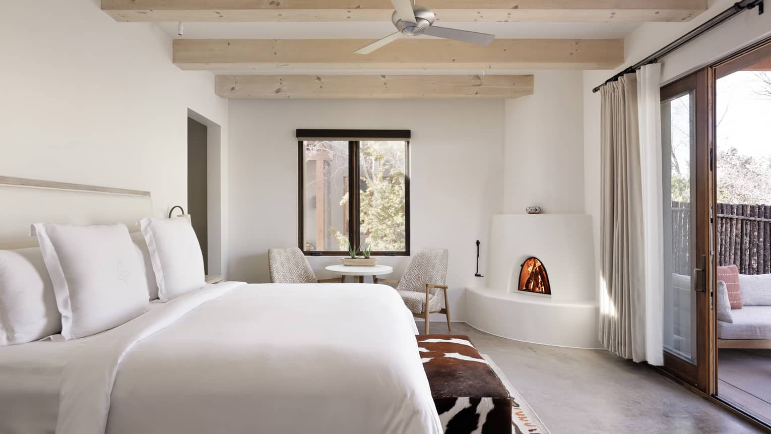 Guest room with king bed and walk-out terrace at Four Seasons Resort Santa Fe