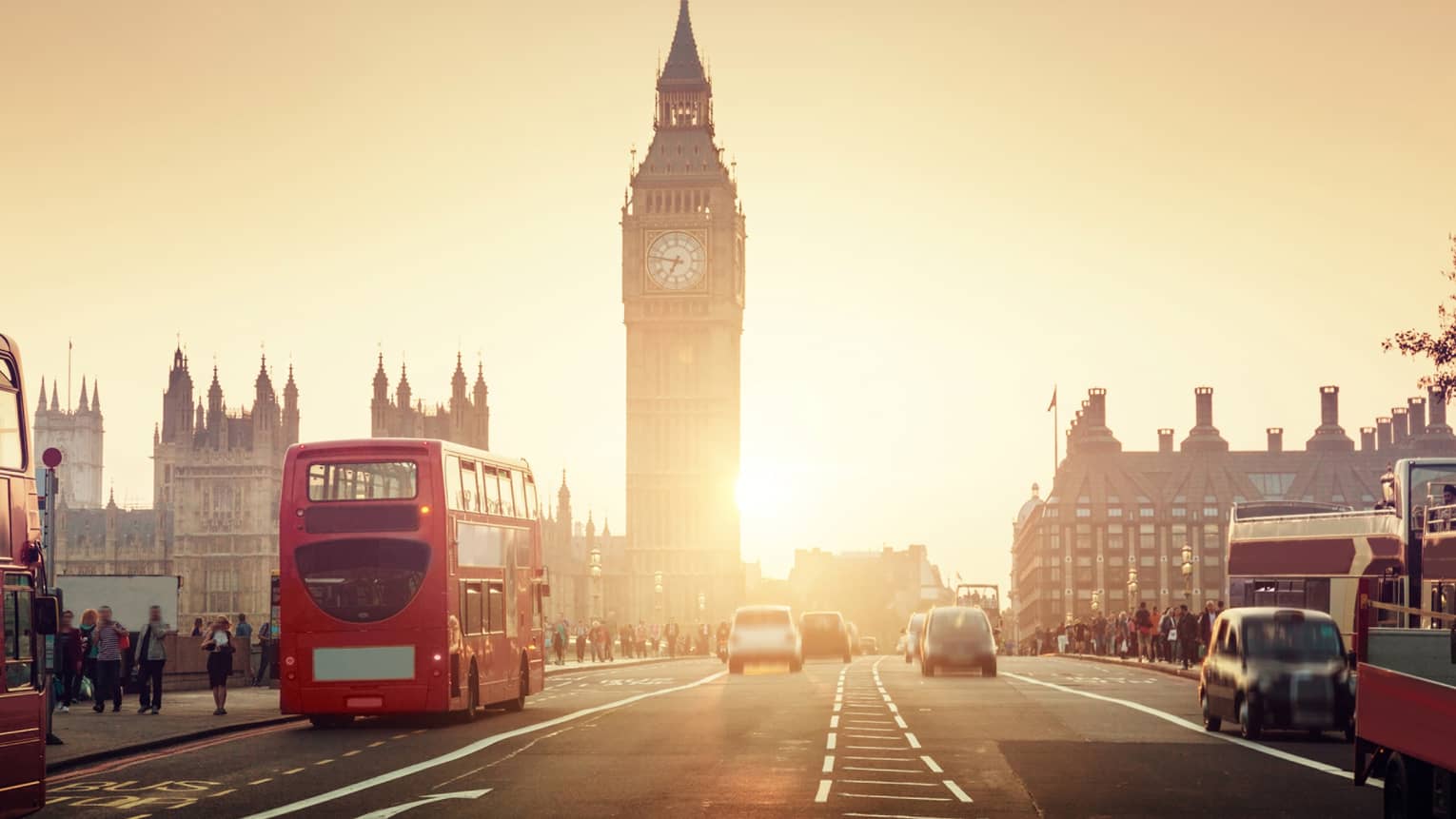 Street view of London at sunset, Big Ben tower and red double-decker bus in background