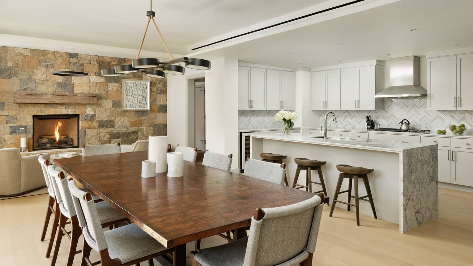 A fire warms the kitchen and dining room in a vail private residence 