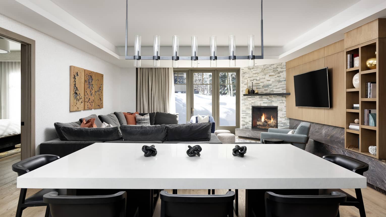 White-topped dining table, 8 black chairs, modern lantern-like lighting fixture