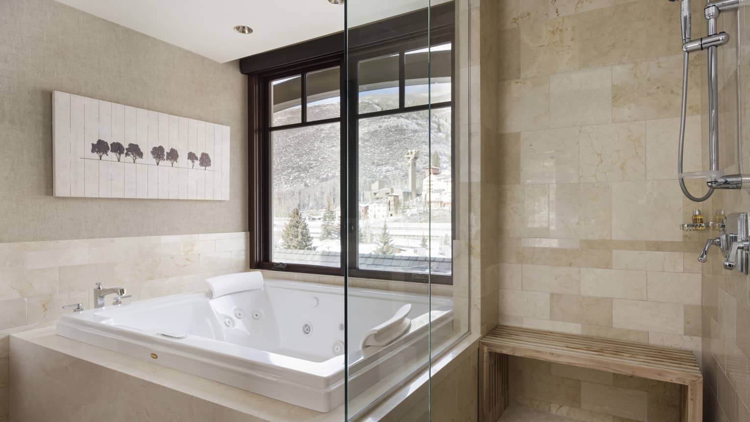 Bathroom with light stone tiled shower, sunken square jetted tub