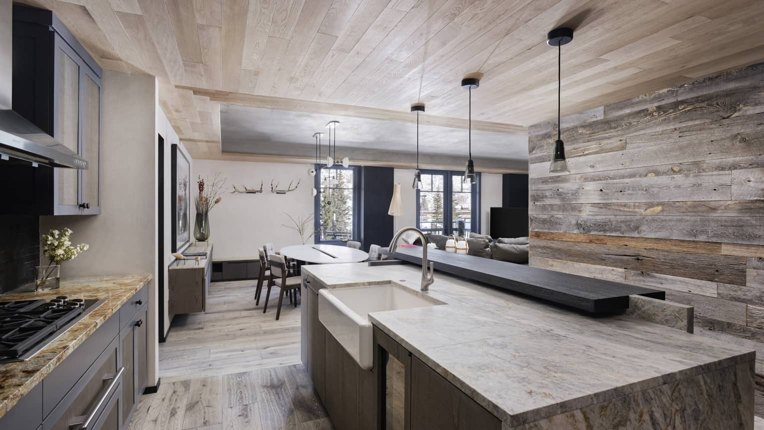 Mountain chic kitchen with wooden ceiling and wall, marble island
