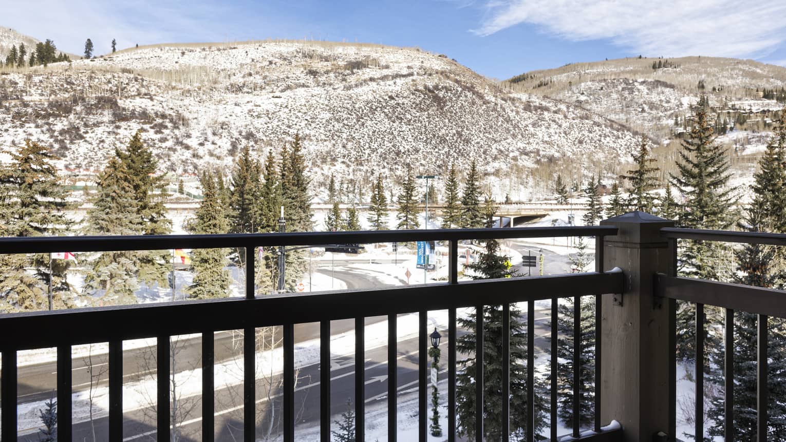 Balcony overlooking mountains lightly covered in snow