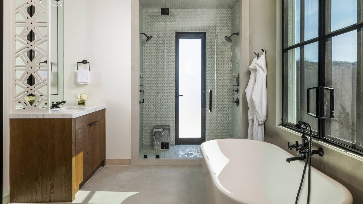 Bathroom with window-side tub and large walk-out shower with two shower heads