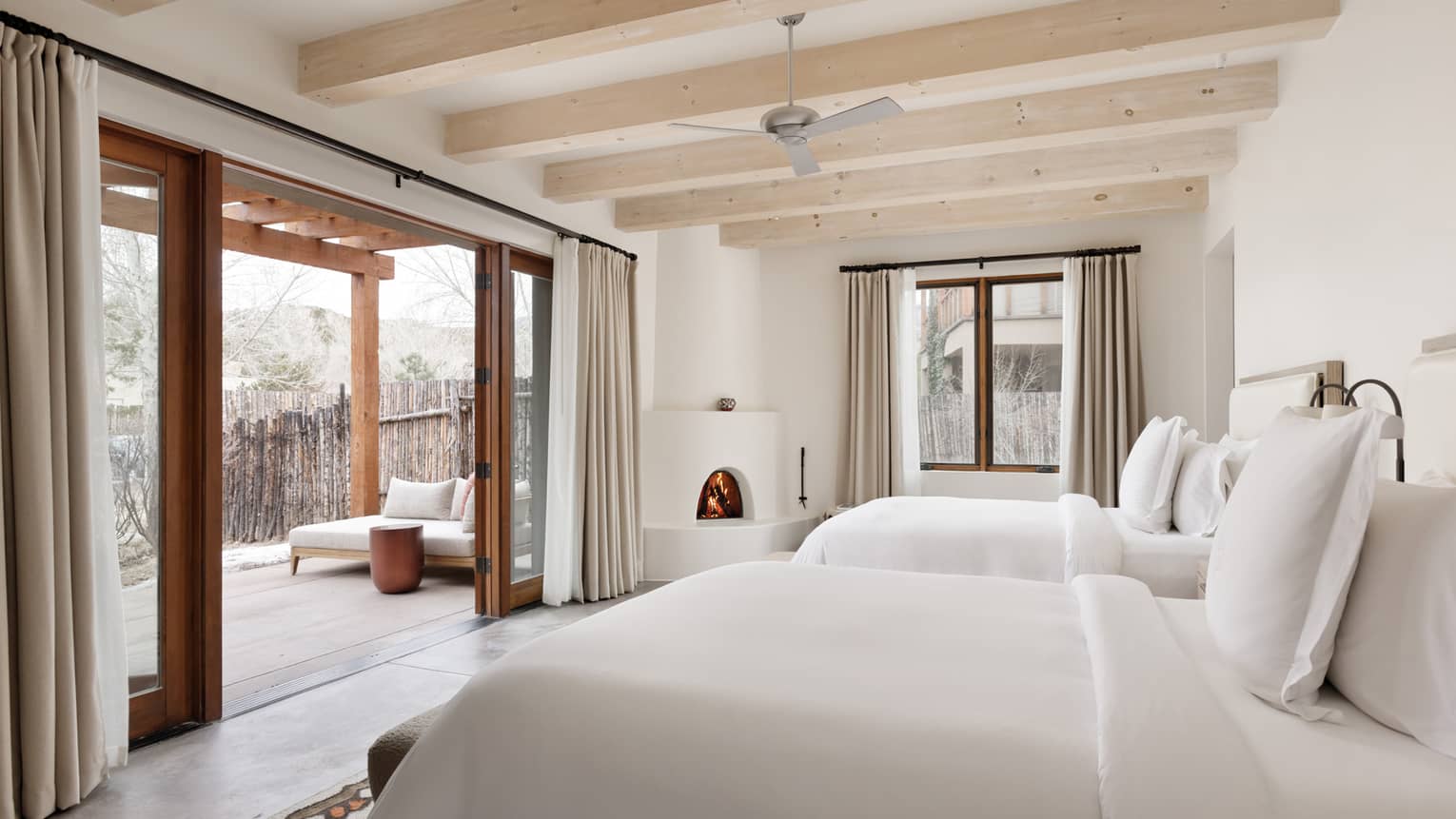 Guest room with two queen beds and walk-out terrace at Four Seasons Resort Santa Fe