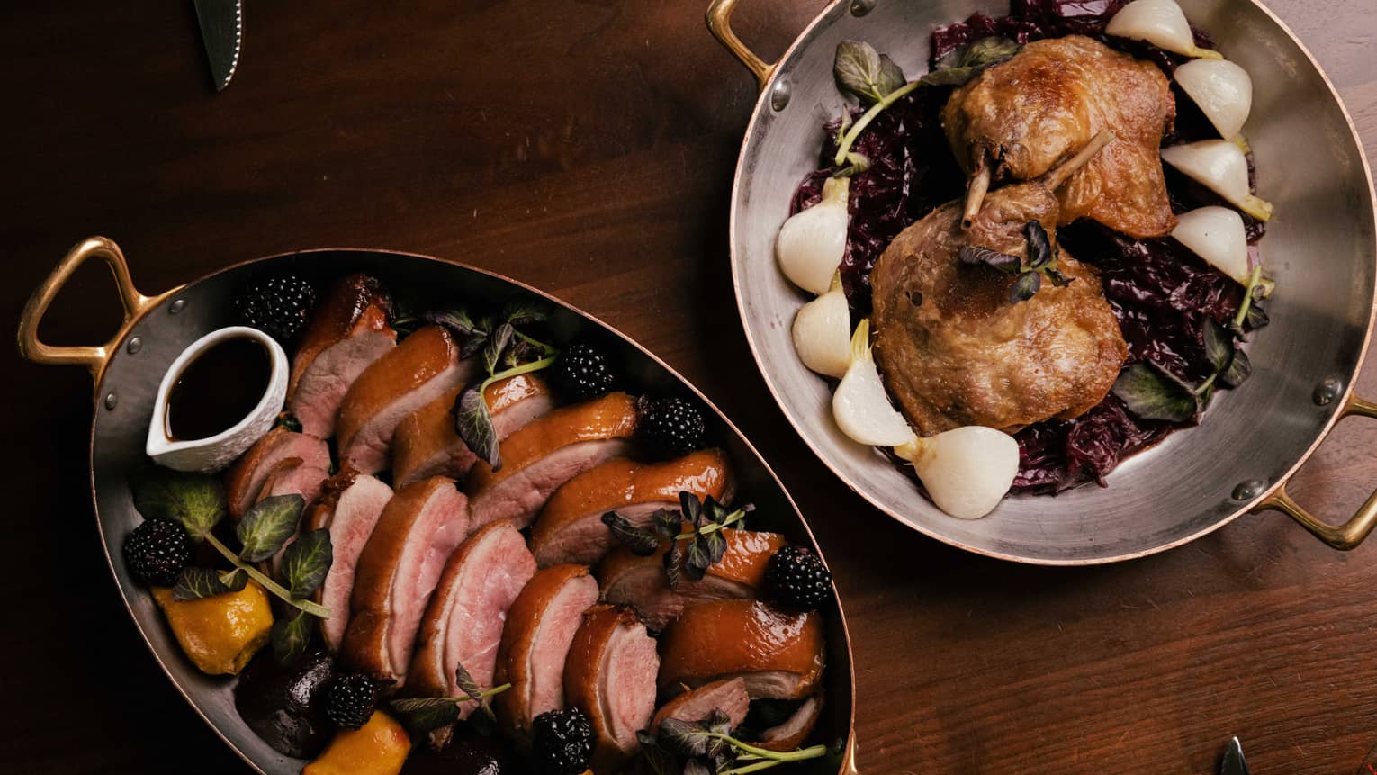 Metal pans of roasted duck and game hens