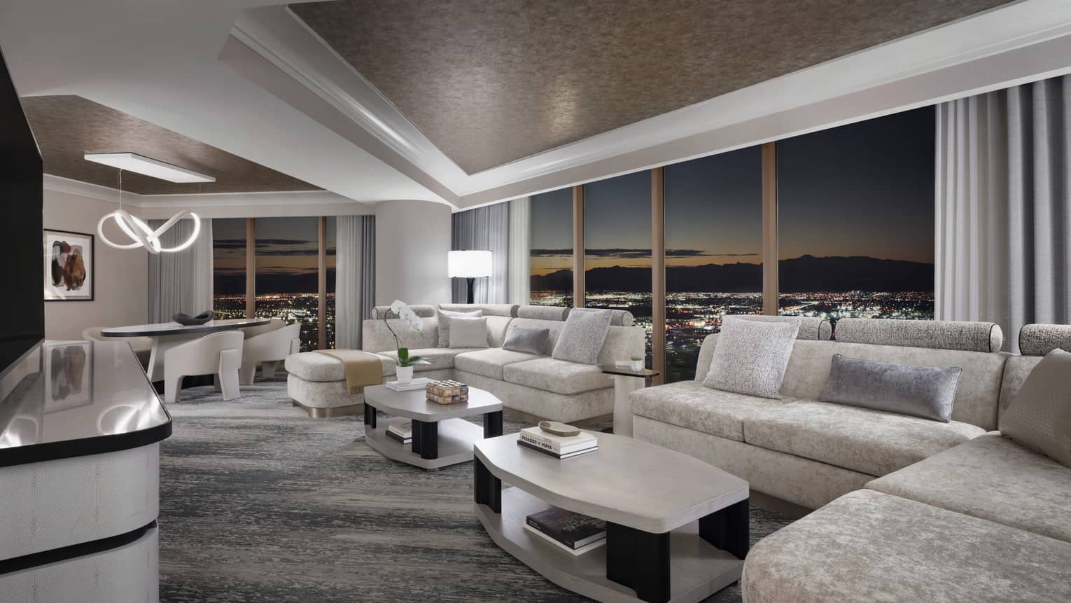 Large living room with two sofas and wall of windows with panoramic Las Vegas view at Four Seasons Hotel Las Vegas
