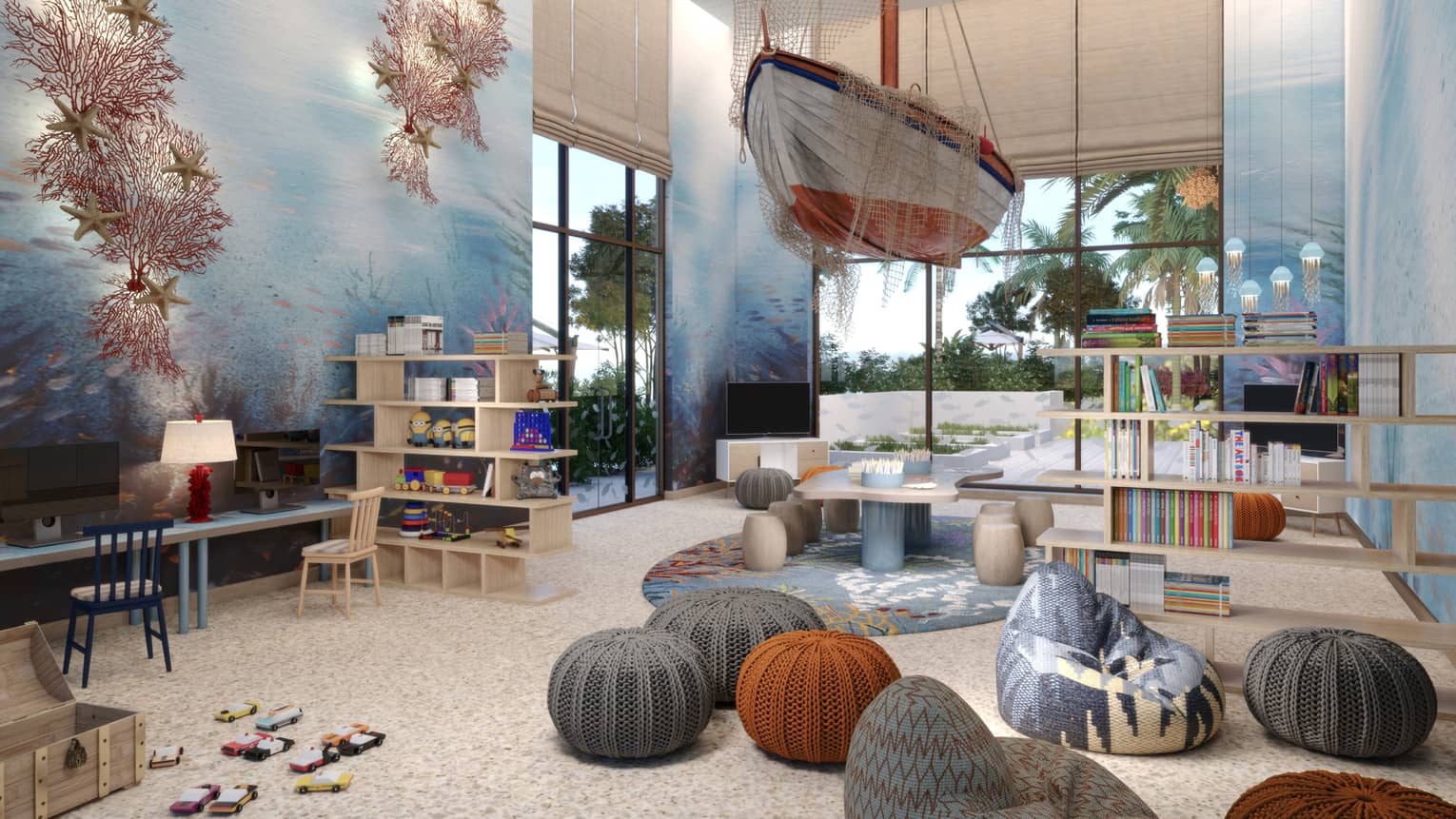 Kids play room with small knit stools, a ship hanging from the ceiling, and underwater mural on the wall