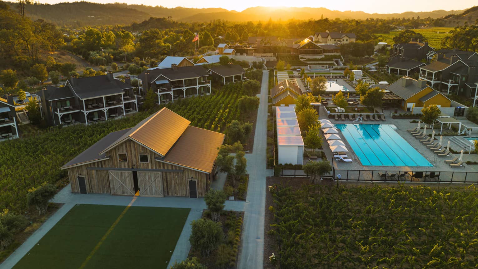 Aerial view of Four Seasons Resort Napa Valley grounds, including pool and vineyards