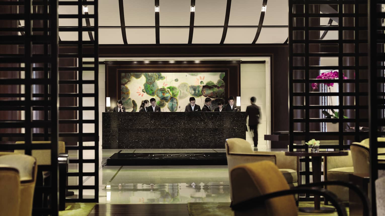 Four Seasons Hotel Hangzhou lobby with black marble reception desk, wood frames