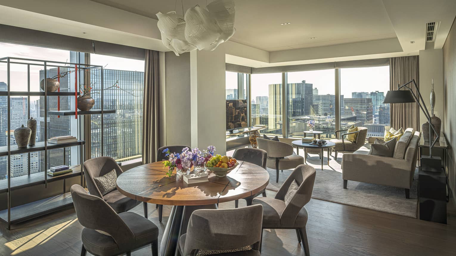 A modern living and dining room area with a city view