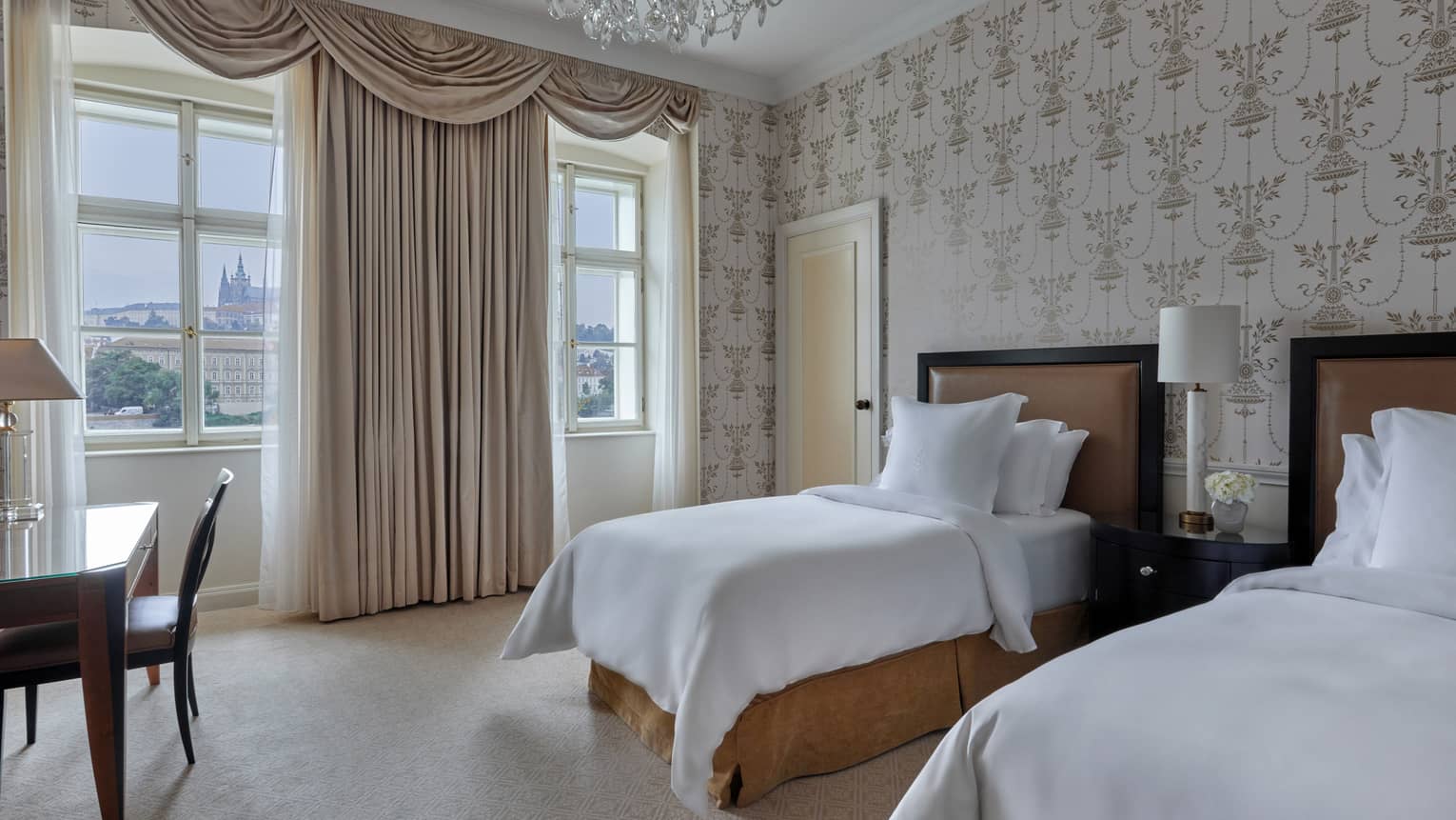 Hotel guest room with two twin beds, wall paper, elegant curtains