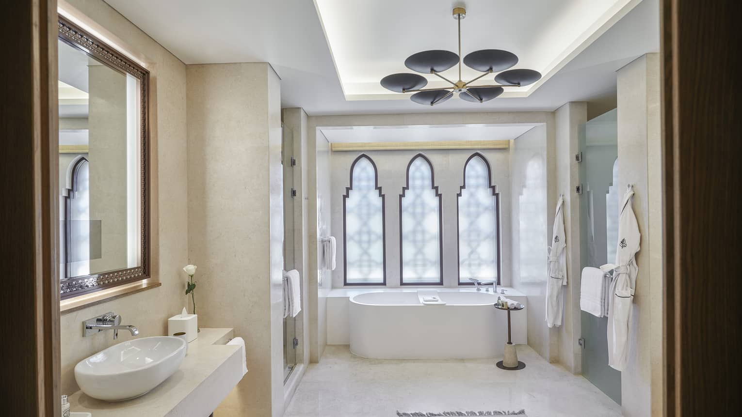 Large bathroom with tub, three windows and hanging light