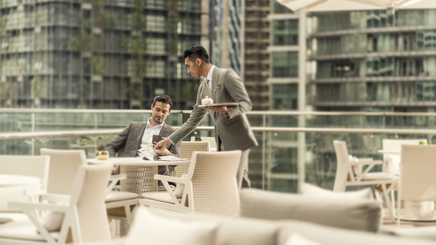 The outdoor terrace of Executive Club at Four Seasons Hotel Kuala Lumpur, with views of KLCC Park
