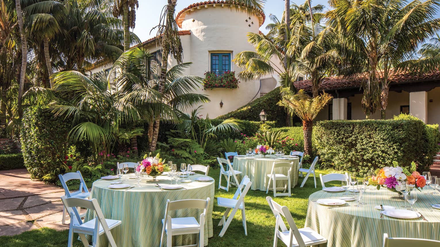 Escala Garden banquet tables on lawn under palm trees 