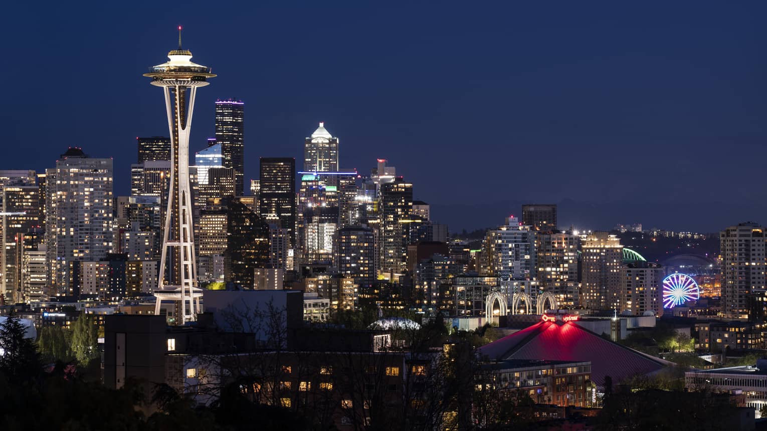 The city of Seattle and the Space Needle are illuminated at night