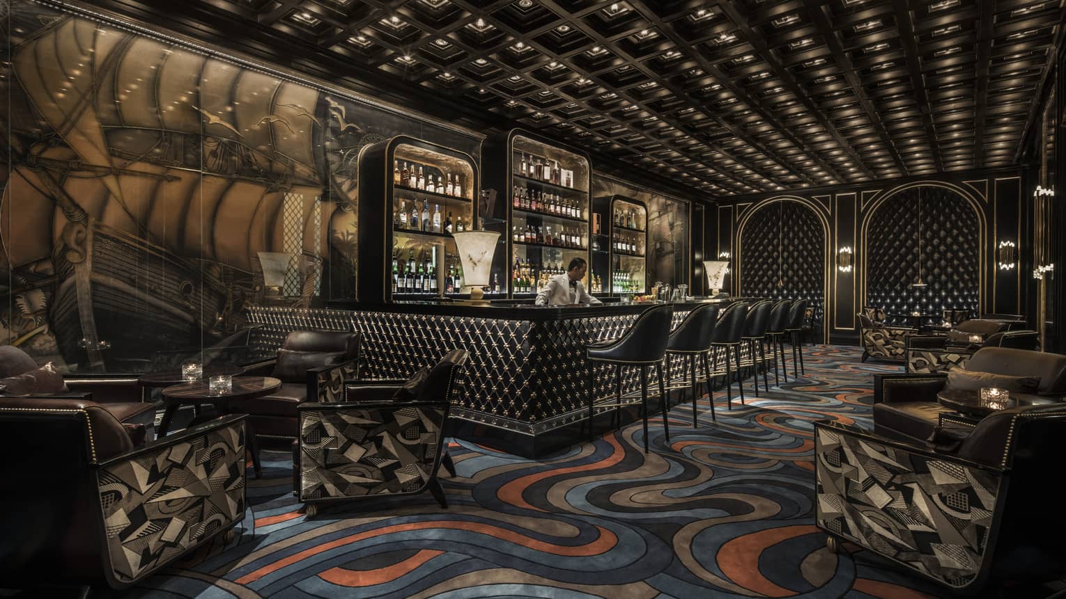 Nautilus Bar with blue-and-orange ocean-like swirled carpet, ship mural on wall, bartender behind bar