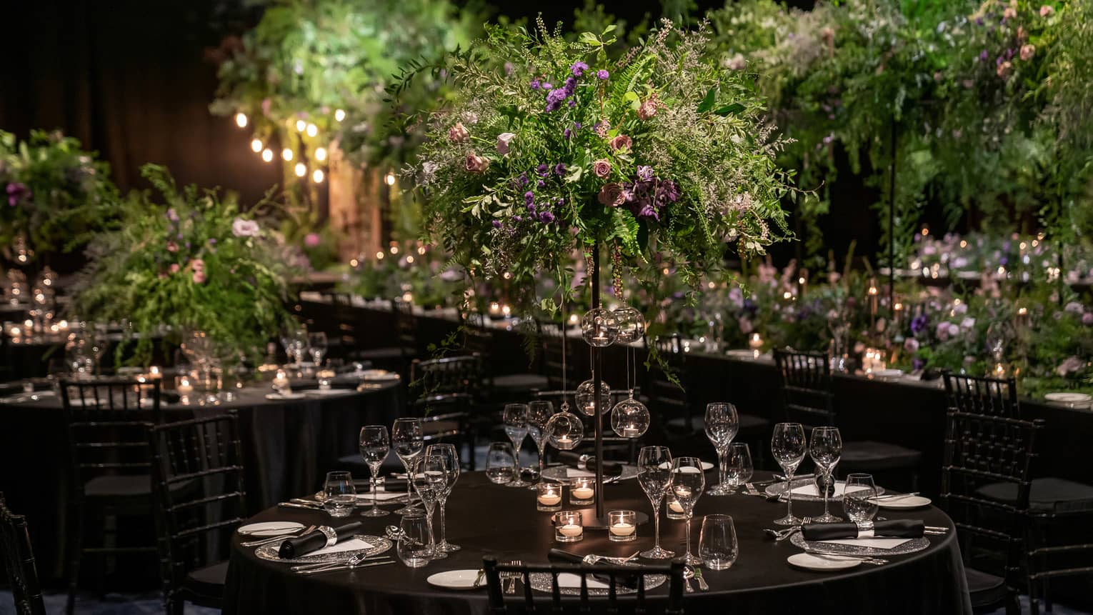 Wedding reception venue with fresh flowers and dark colour scheme