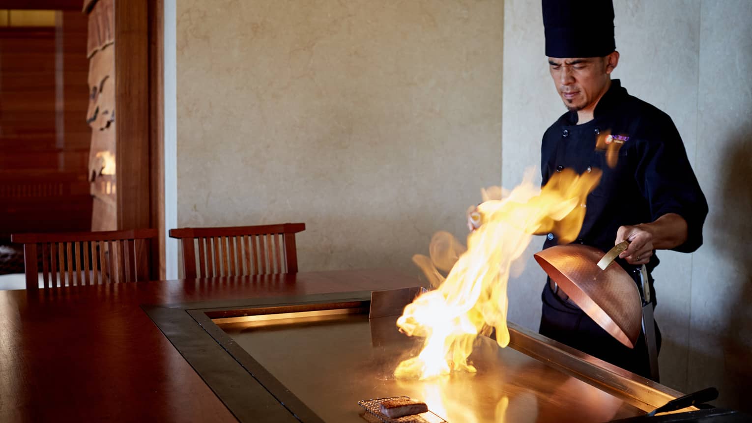 Flames shoot up from grill as NOBU restaurant chef pulls back copper lid