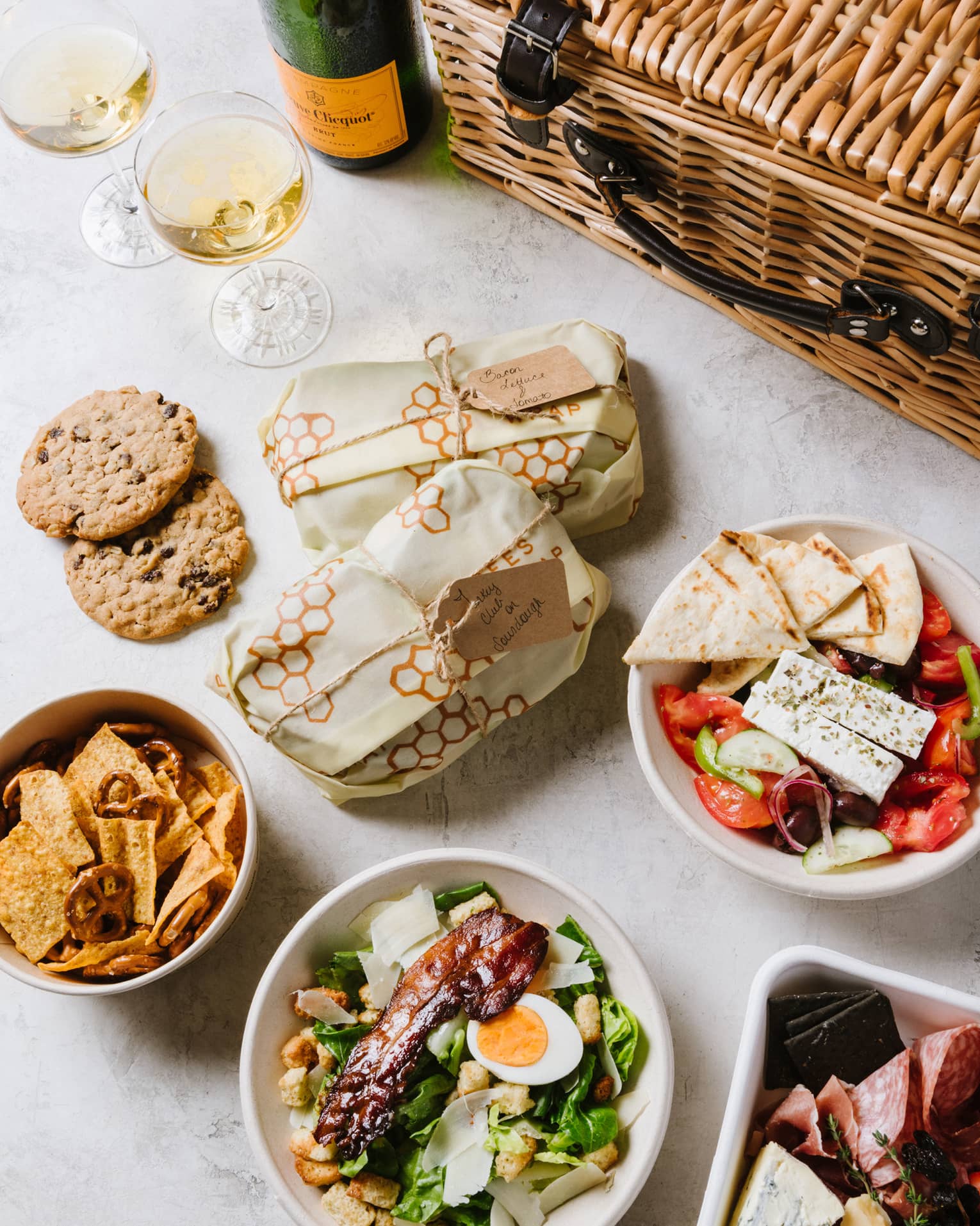 An assortment of food including salad, cookies and bread.