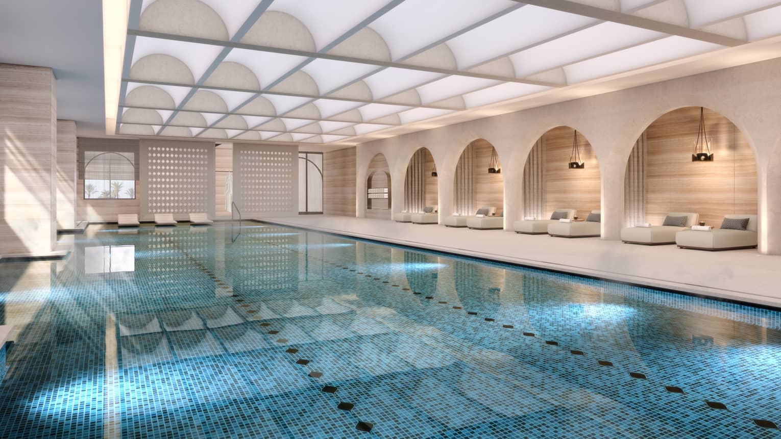 Indoor pool with daybeds lining the wall