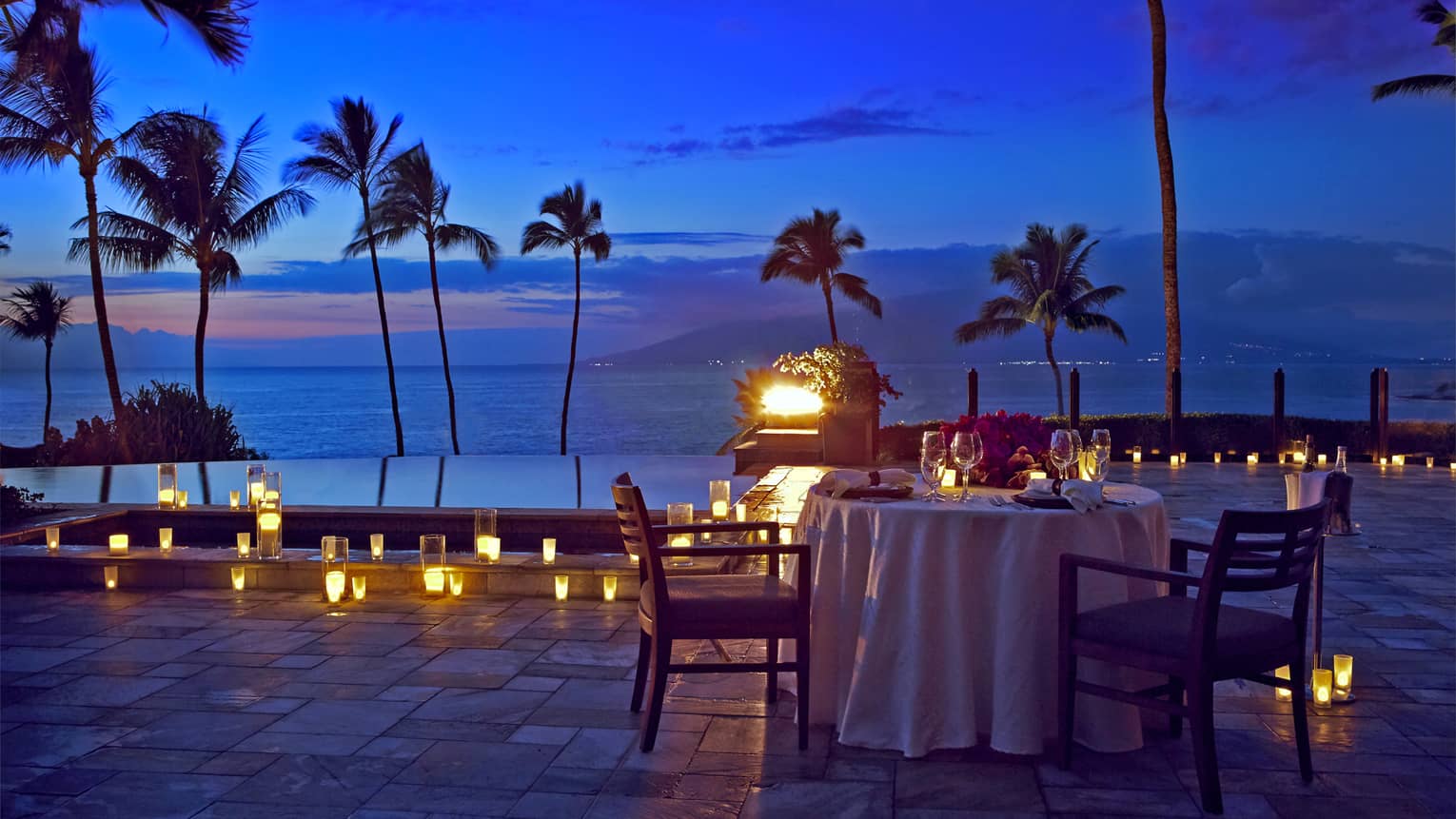 An outdoor candlelit dinner by the seaside in Maui