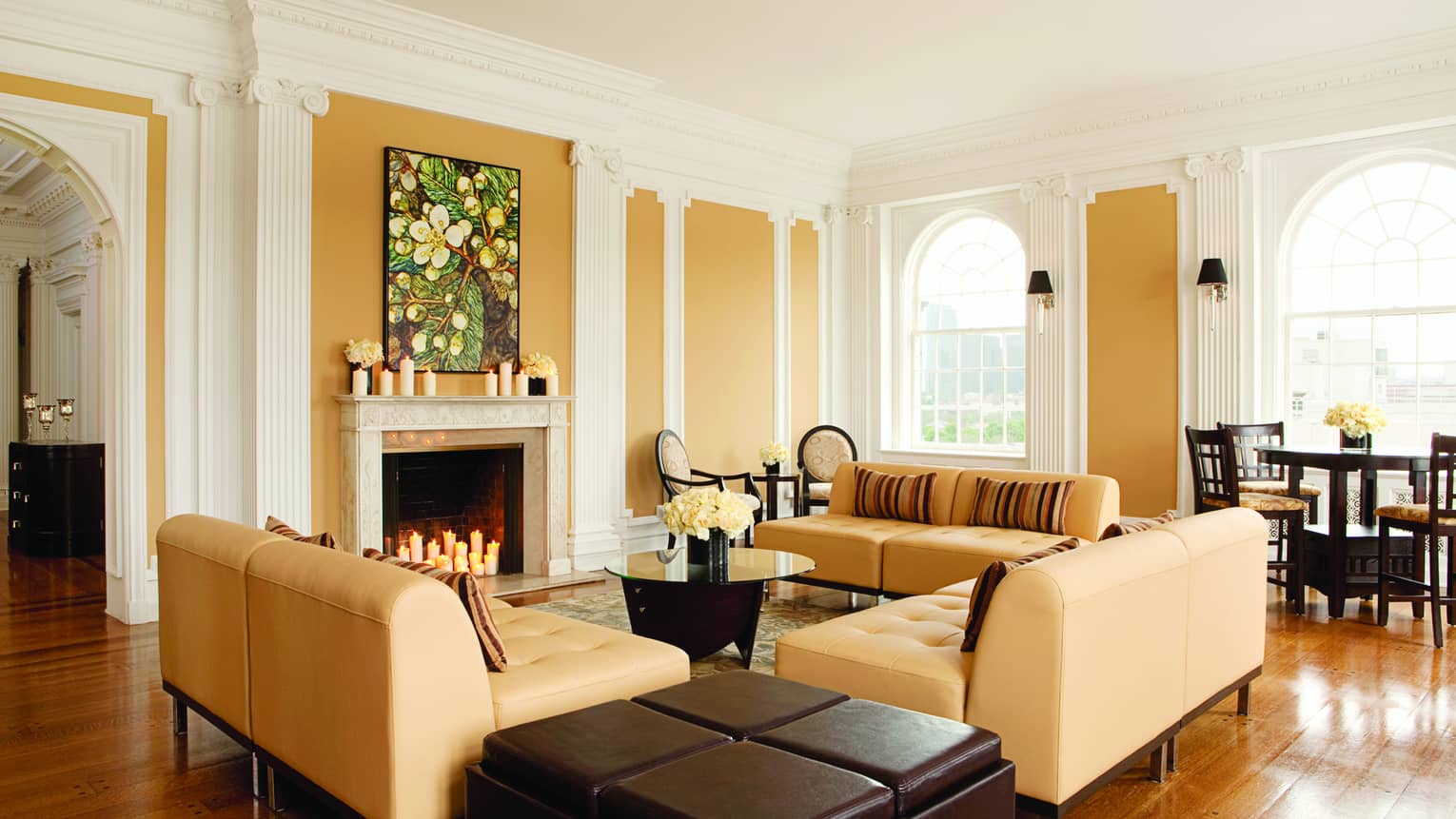 Tan sofas around fireplace in modern Royal Suite Living Room 