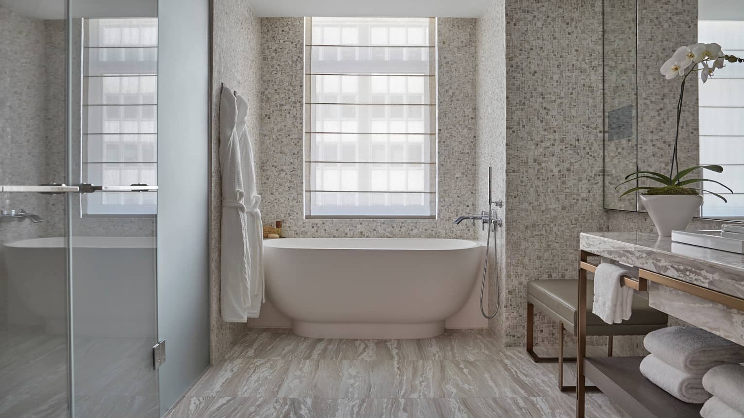 Corner Room bathroom with glass walk-in shower, white freestanding tub, vanity, white orchid