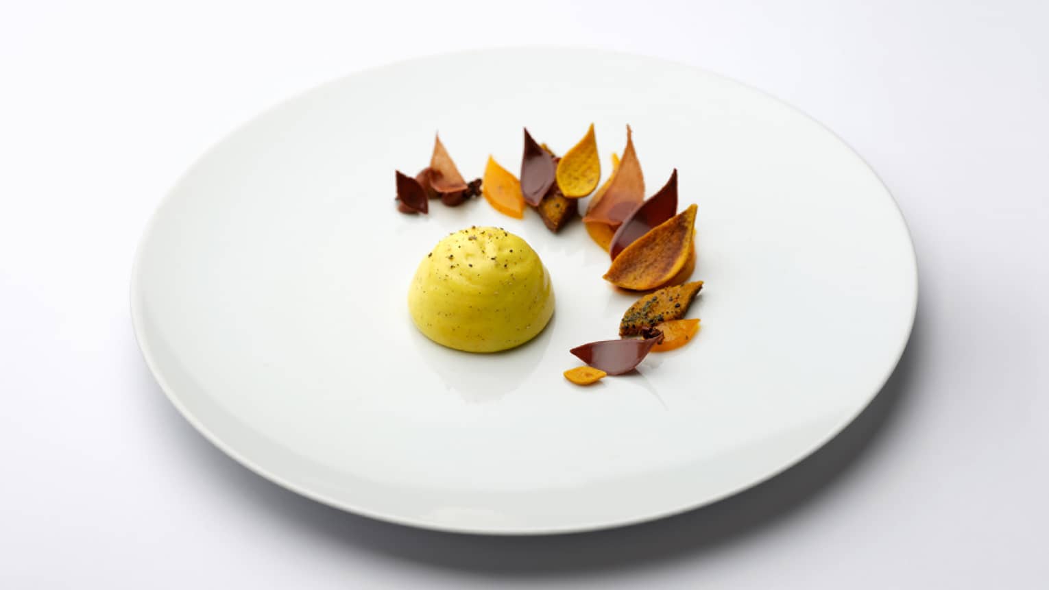  Confit Passion Fruit Dome with Ginger and Cocoa Nibs and Curry Madras on white plate