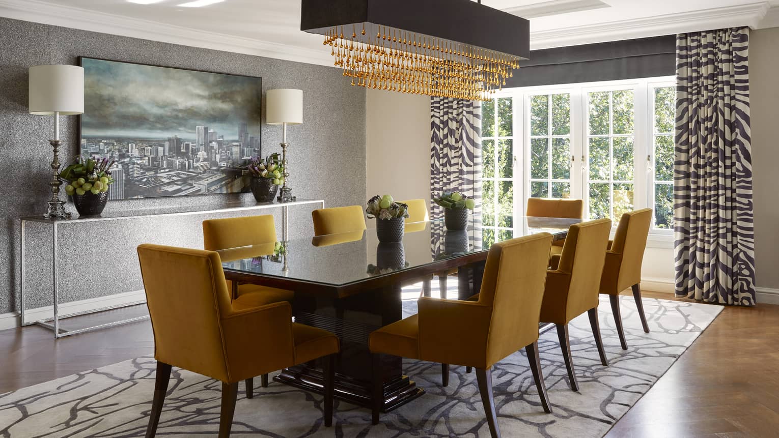 Luxury hotel suite dining room table with eight mustard-coloured velvet chairs at Four Seasons Hotel Johannesburg